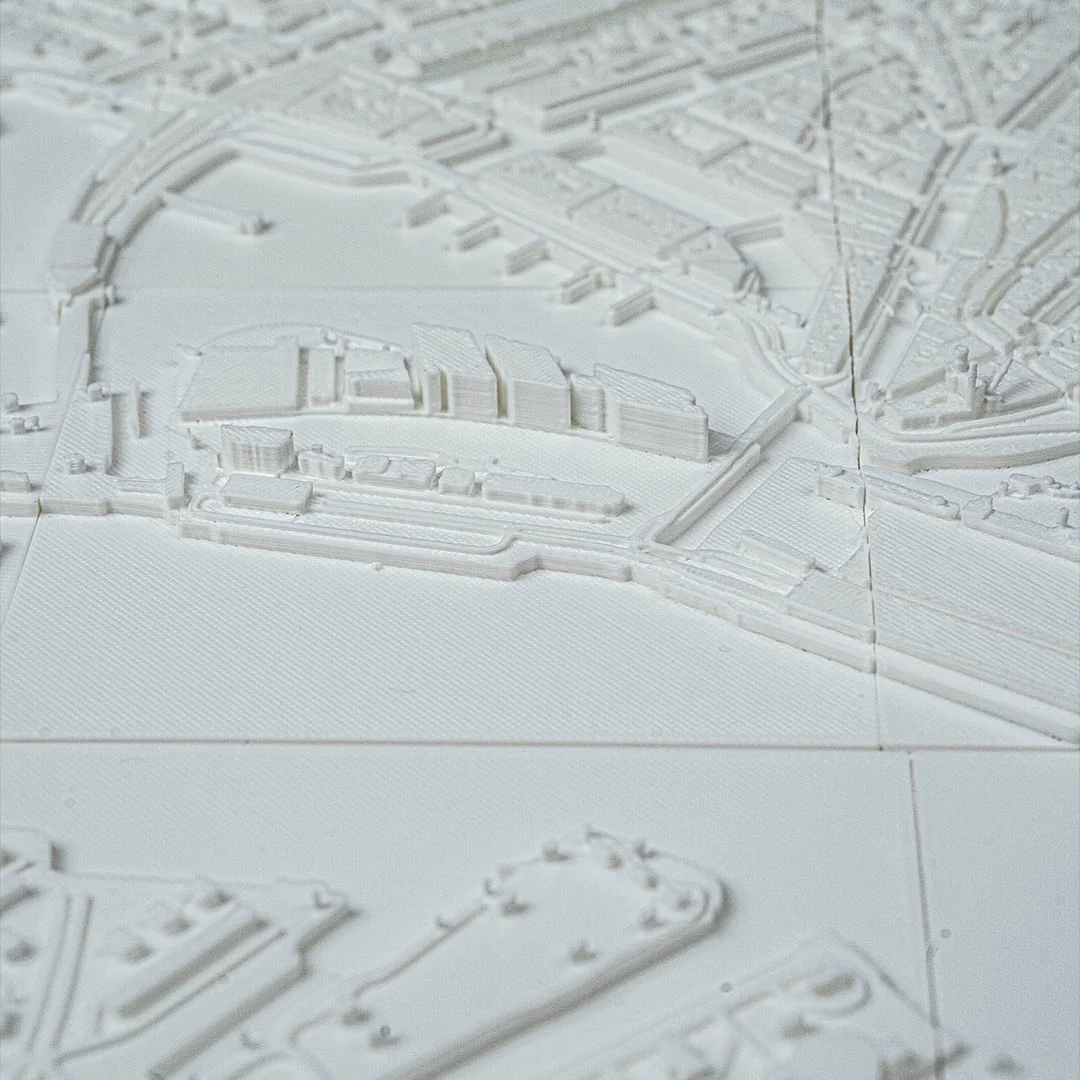 Low angled view of an Amsterdam relief map showing raised waterfront buildings.