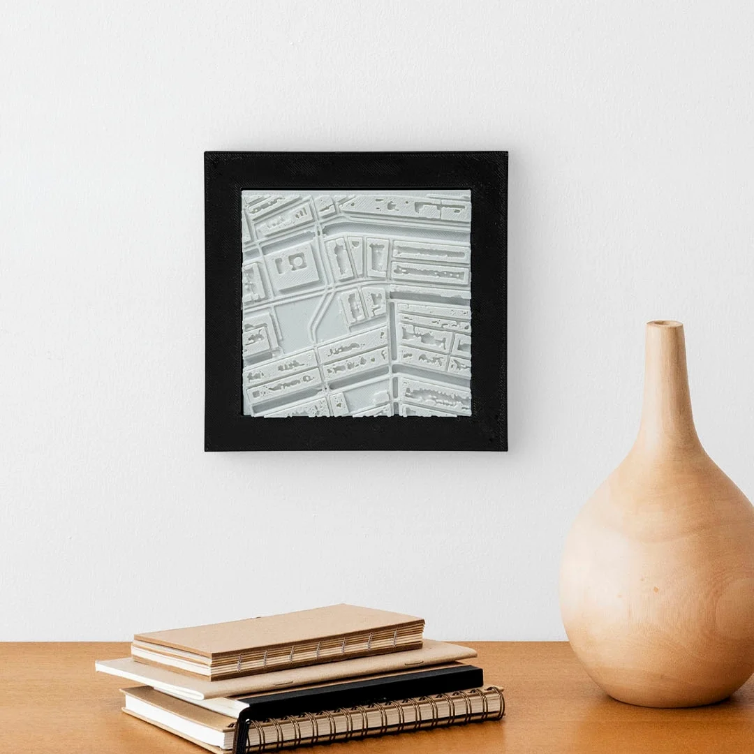 Framed Amsterdam city relief map displayed on a wall.