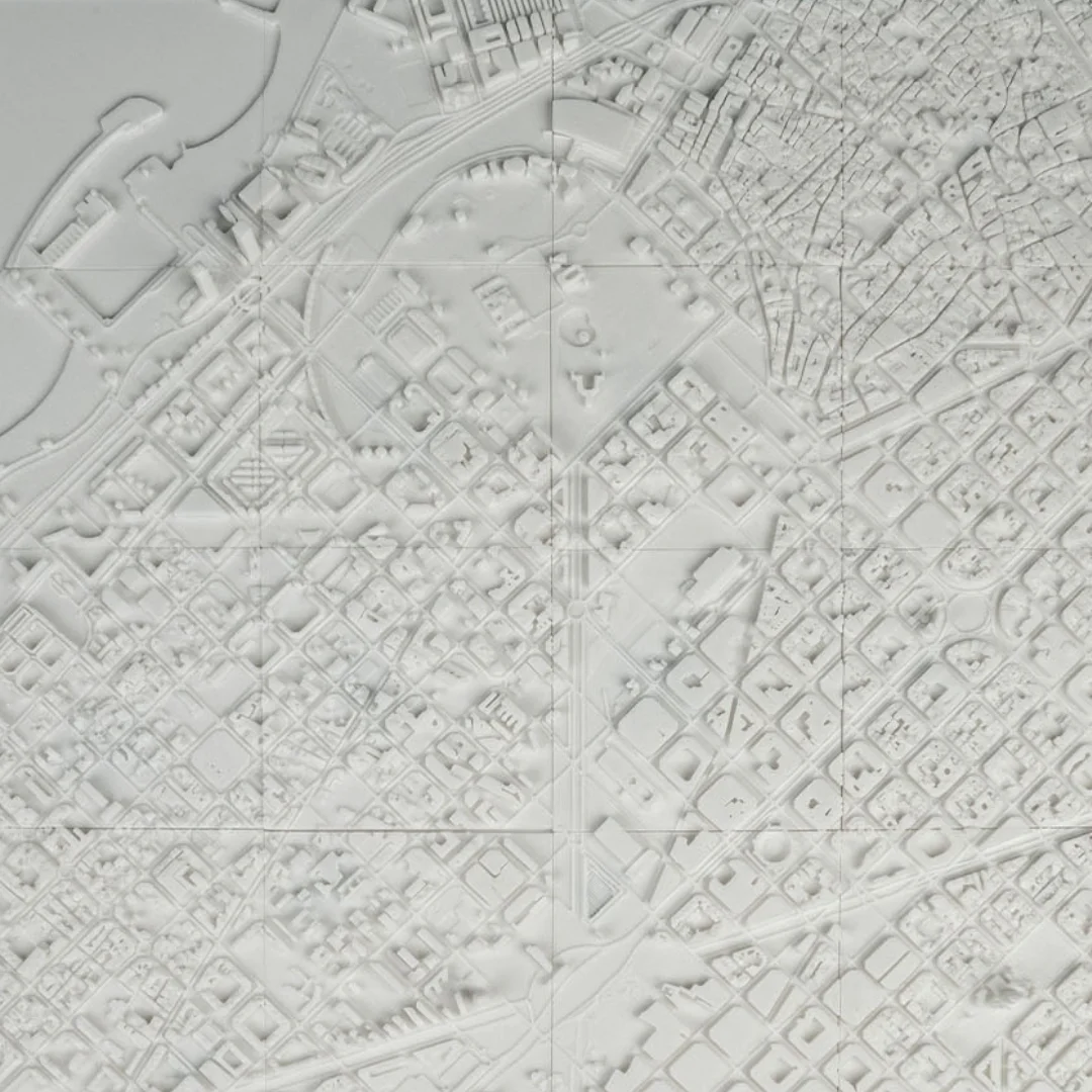 Overhead view of a Barcelona relief map showing the city block layout.