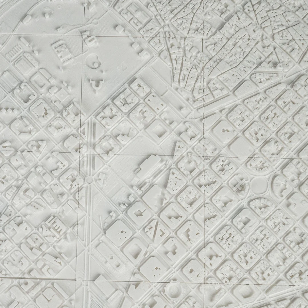 Overhead detail of a Barcelona relief map showing buildings and open spaces.