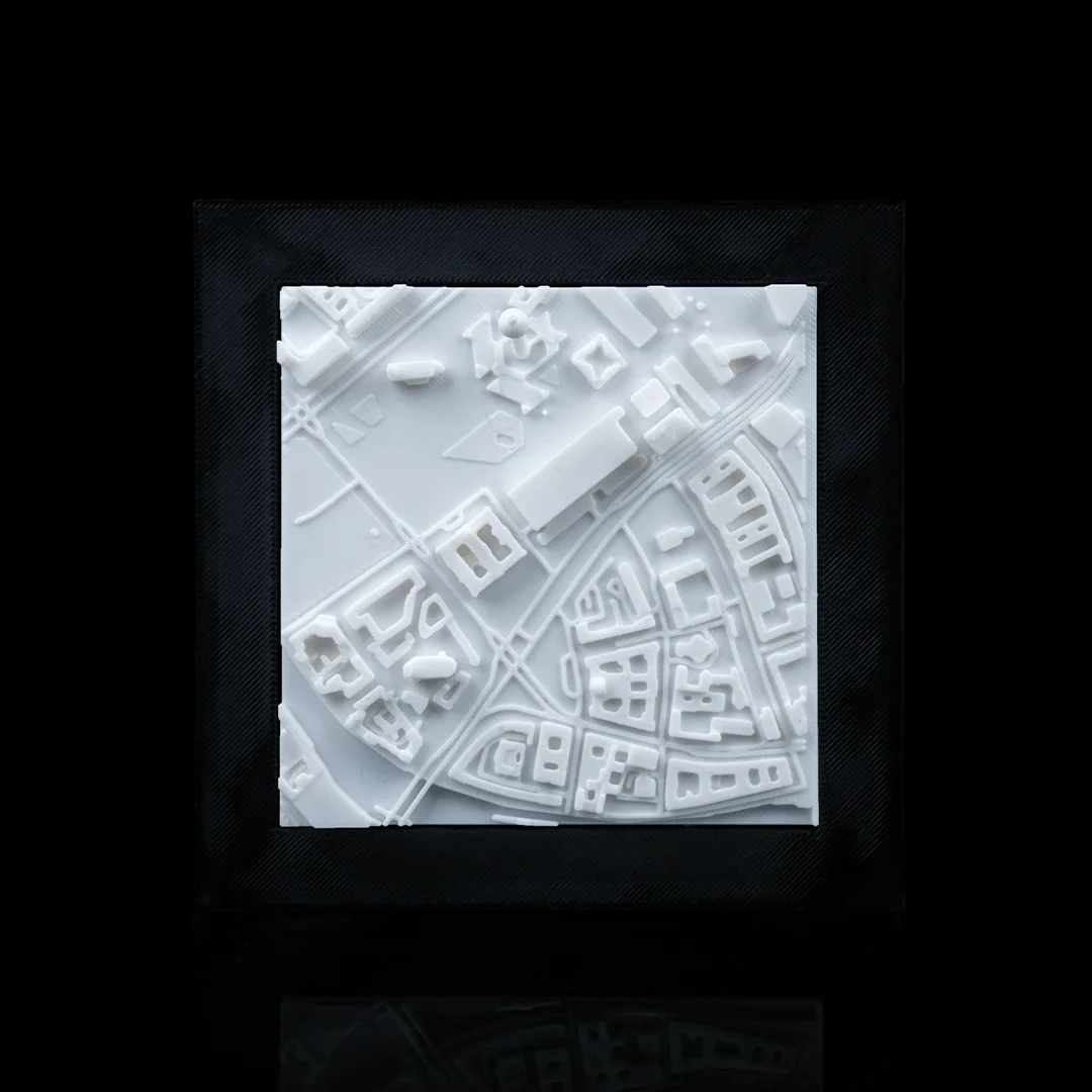 Framed Berlin city relief map showing raised buildings and streets.