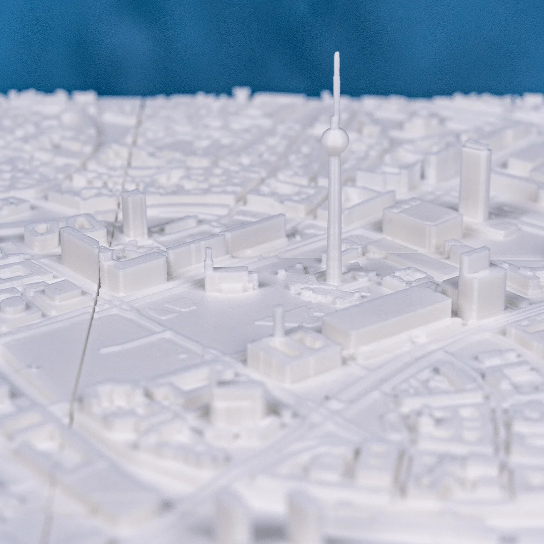 Close view of a slender tower and surrounding buildings in a Berlin relief map.