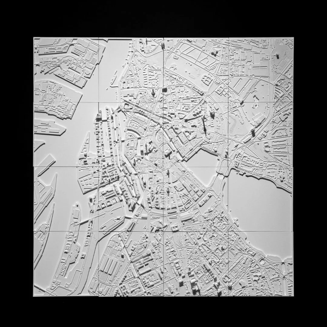 Overhead view of a Hamburg relief map showing the city layout and waterways.