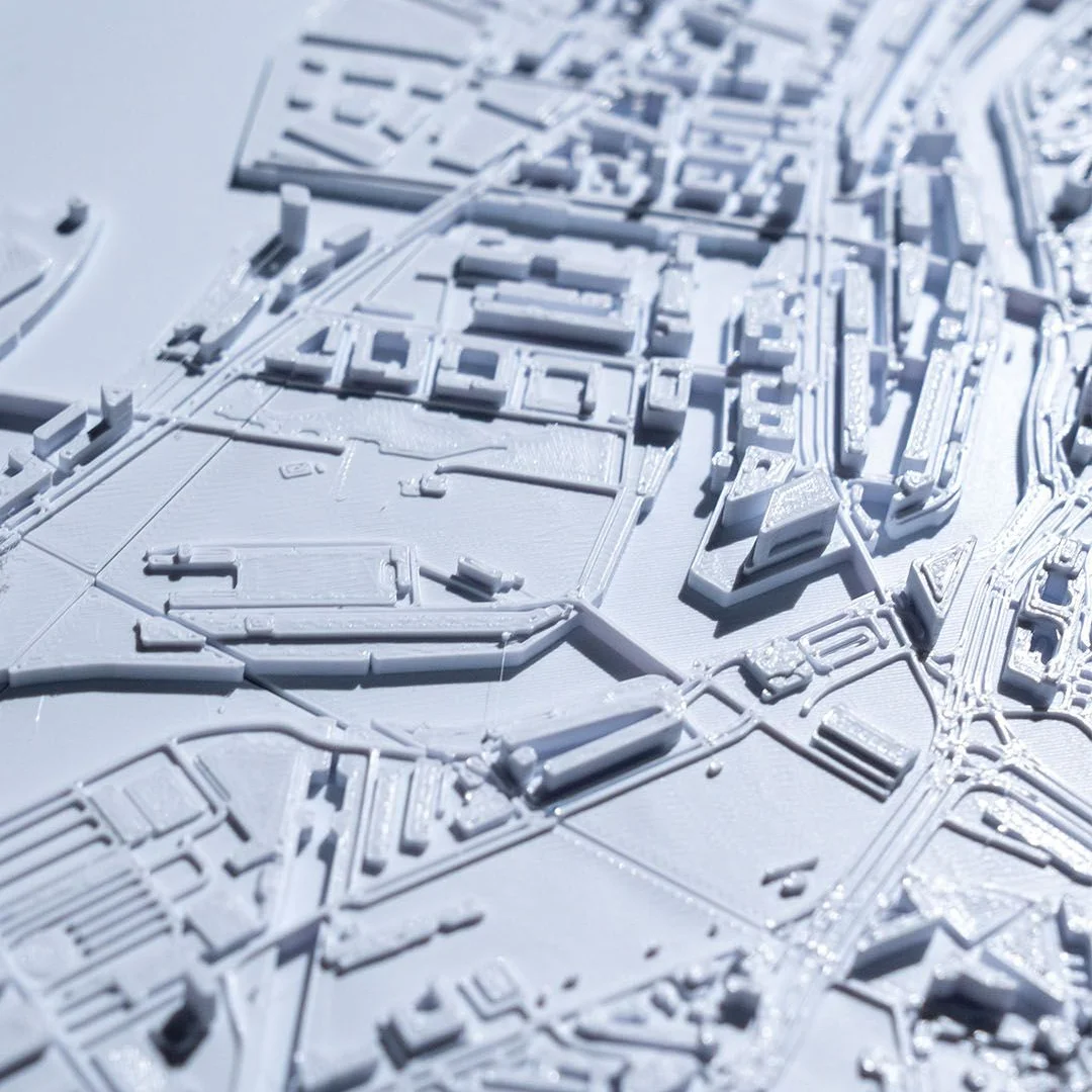 Angled detail of buildings and waterways in a Hamburg city relief map.