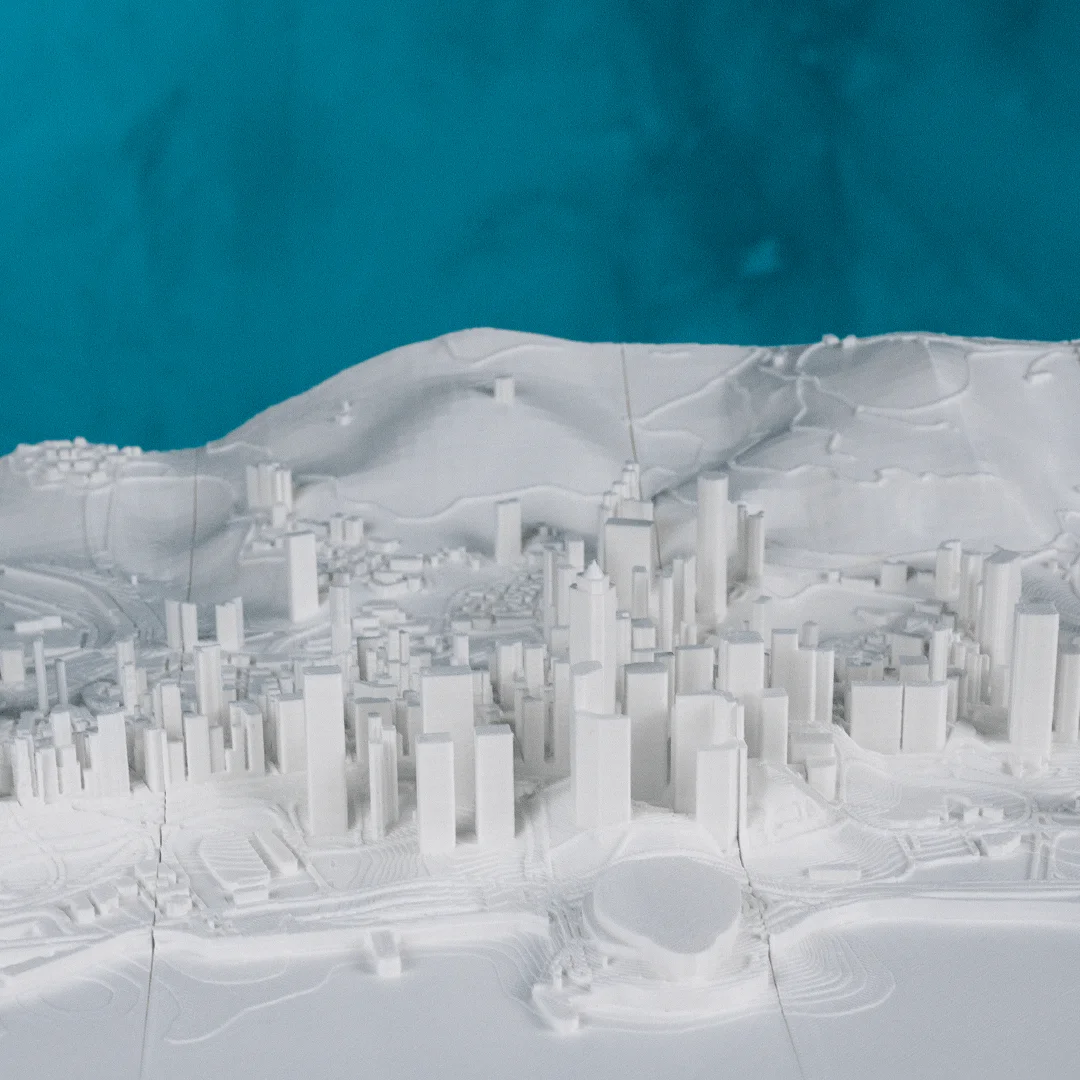 Wide view of a Hong Kong city relief map showing urban buildings and hills.