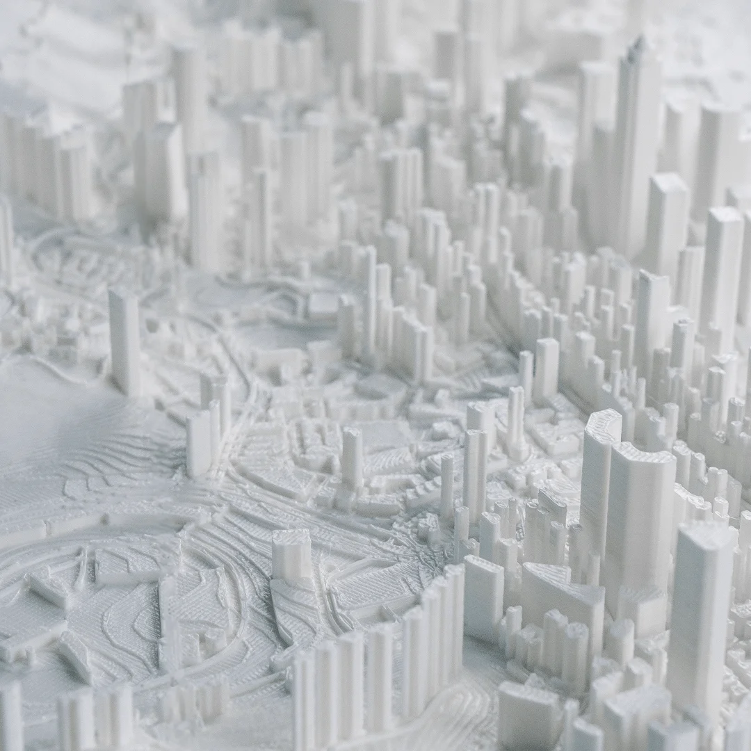 Close angled view of dense building clusters in a Hong Kong city relief map.