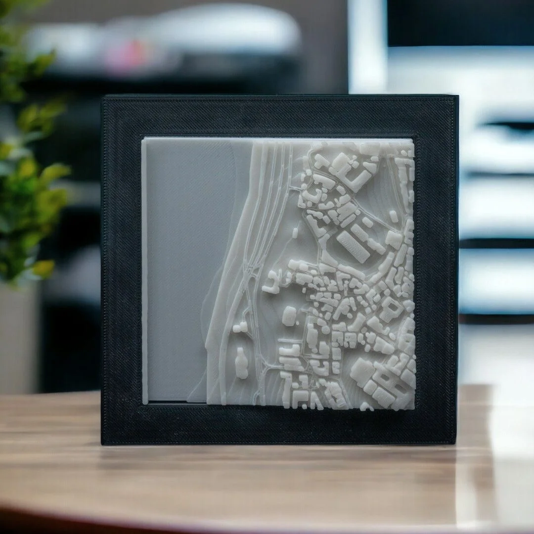 Framed Istanbul city relief map displayed upright, showing waterfront buildings.