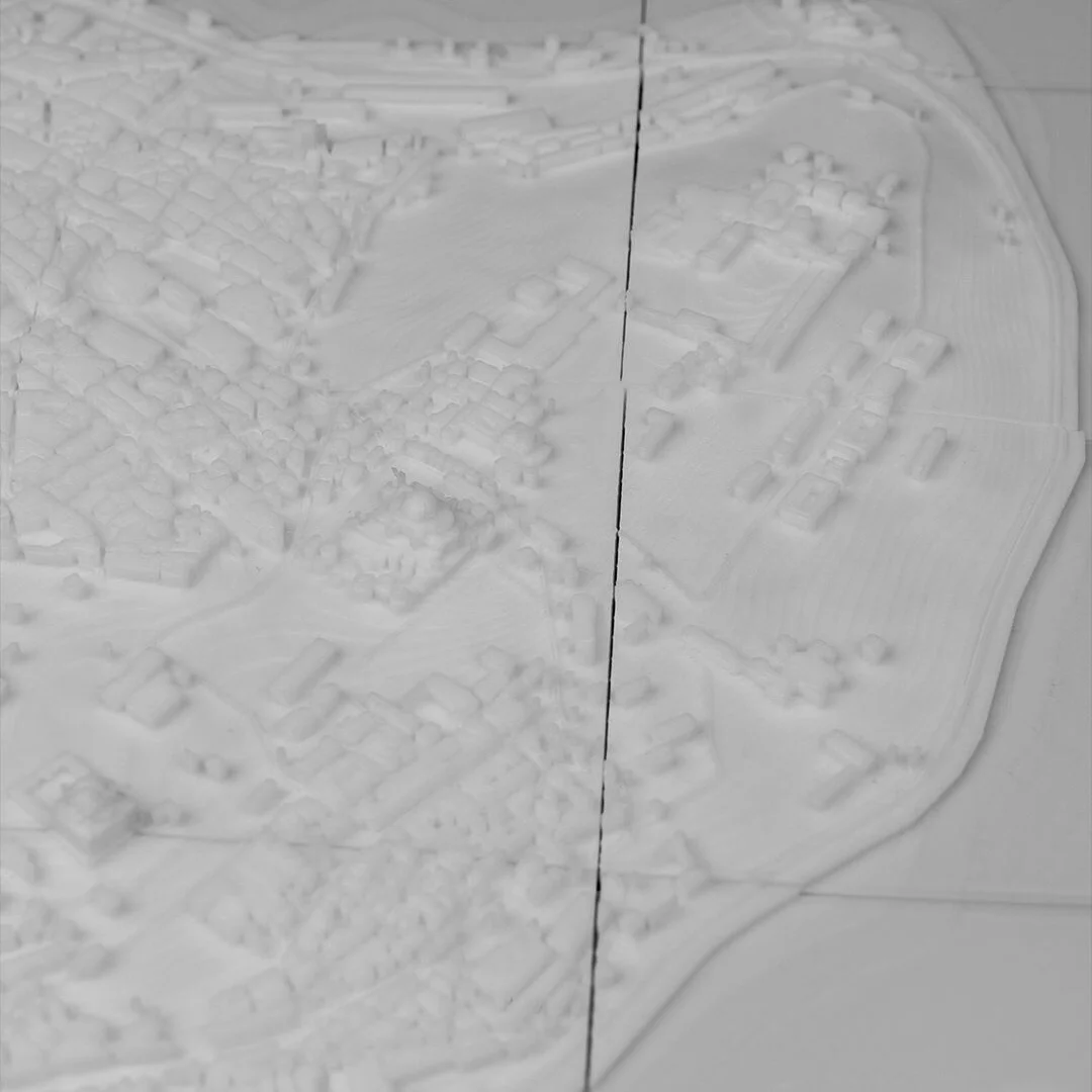 Overhead detail of coastline and buildings in an Istanbul city relief map.