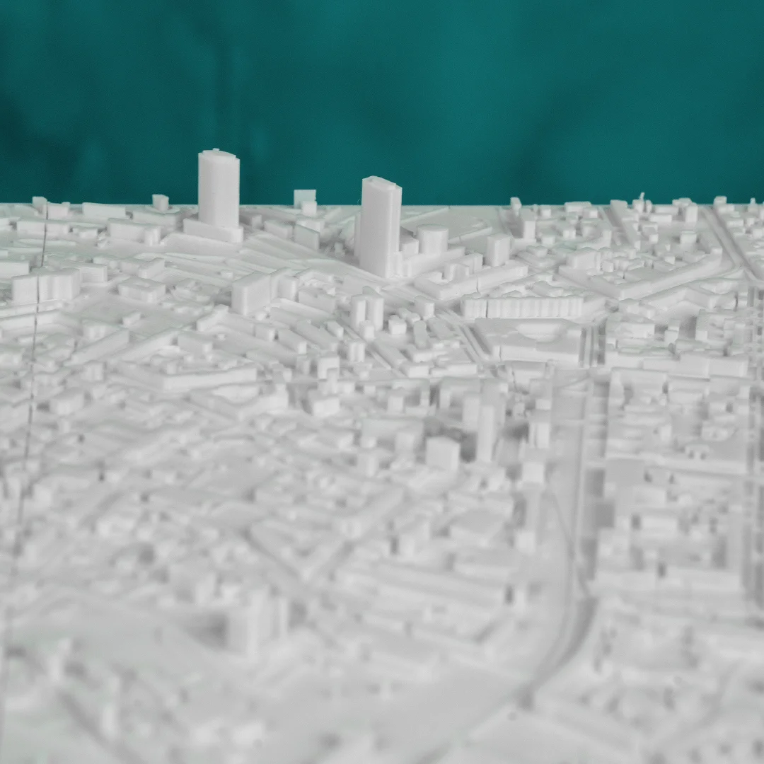 Low view across a Kyiv city relief map showing raised buildings.