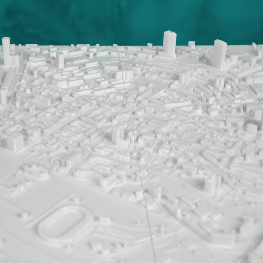 Angled view of a Kyiv relief map showing urban blocks and an oval stadium.