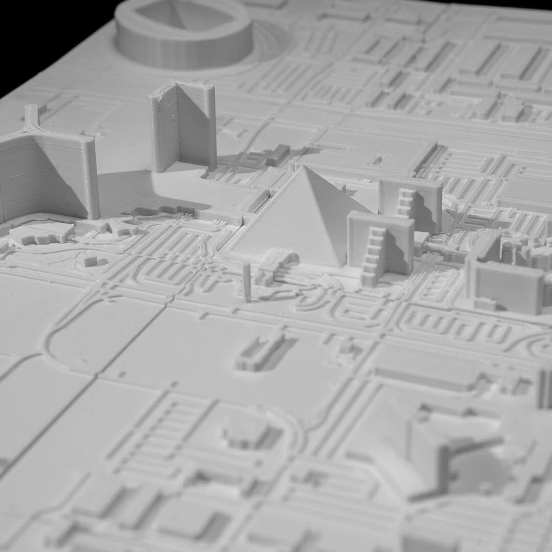 Angled detail of pyramid-shaped and other buildings in a Las Vegas relief map.