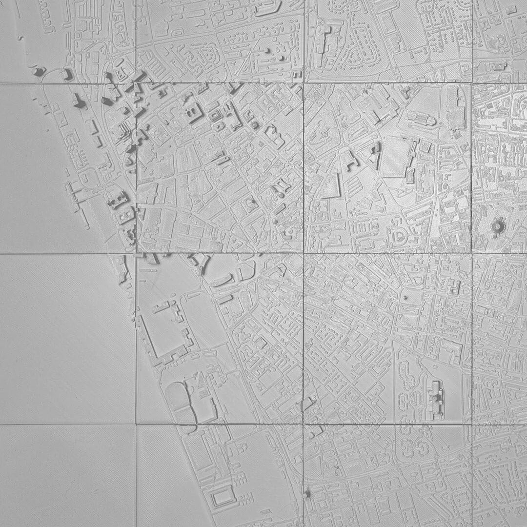 Overhead detail of a Liverpool relief map showing streets and waterfront areas.