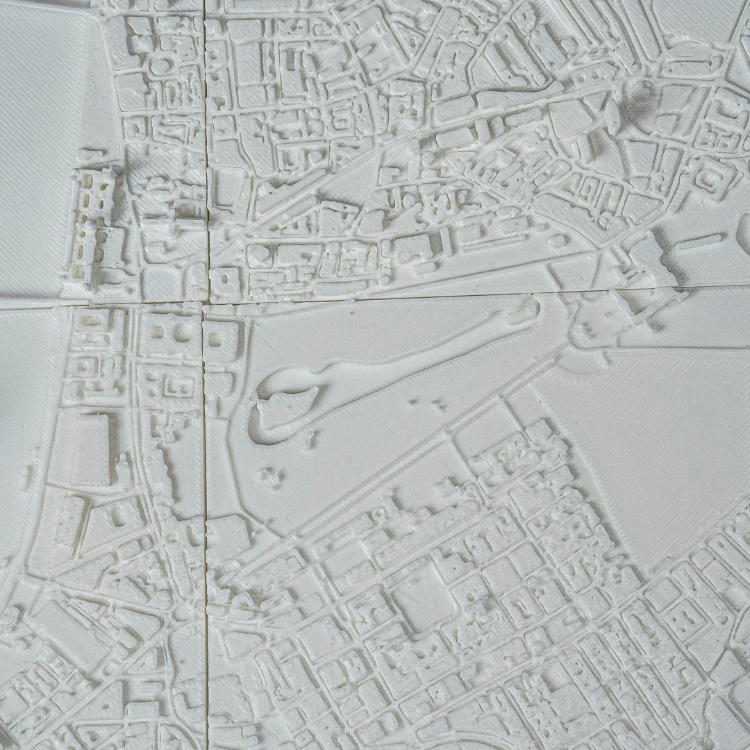 Angled view of raised buildings and bridges in a London city relief map.