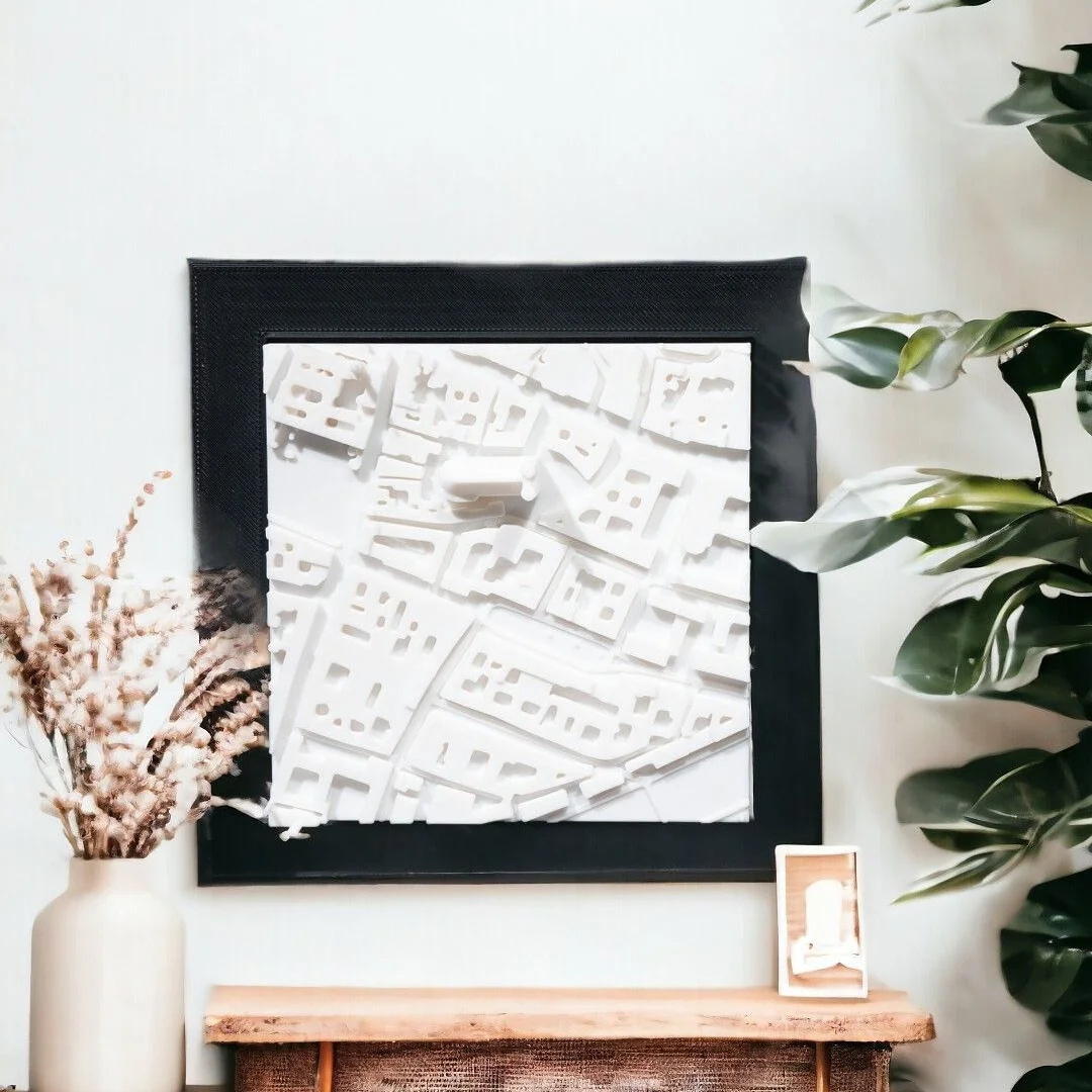 Framed Munich city relief map displayed on a wall.