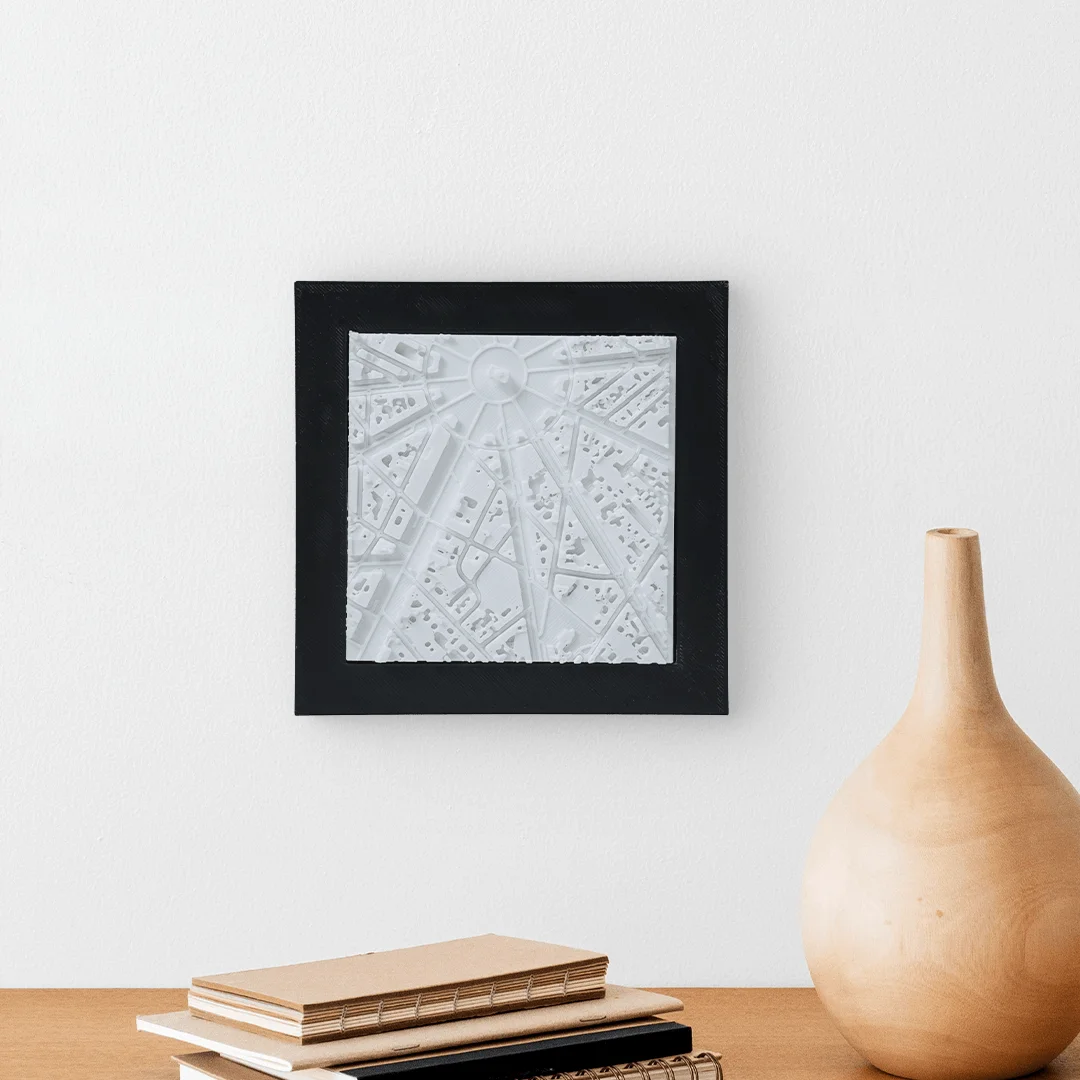 Framed Paris city relief map displayed on a wall.