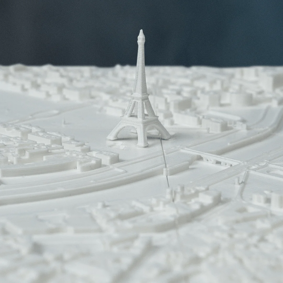 Close view of the Eiffel Tower in a Paris city relief map.
