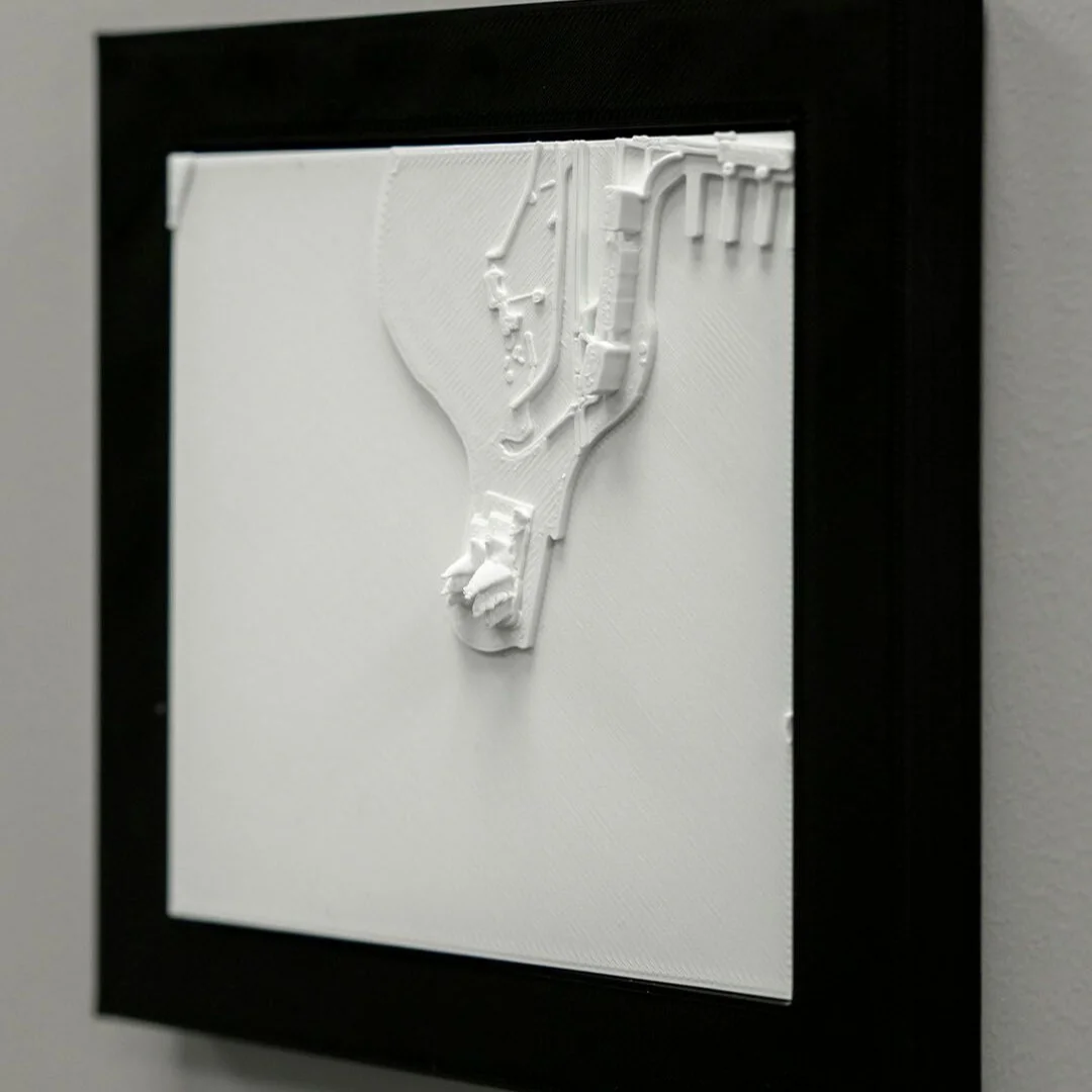 Angled view of a framed Sydney harbour relief map.