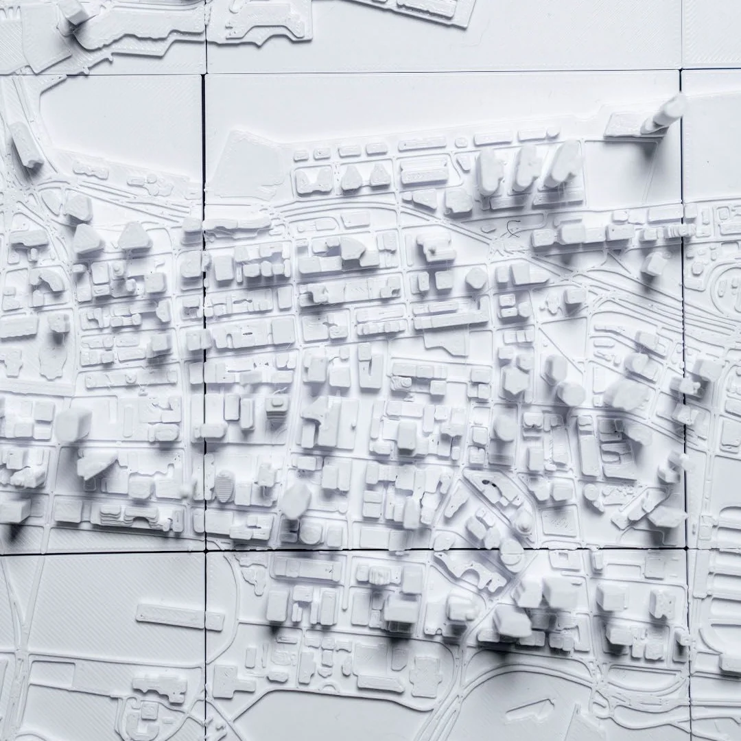 Overhead detail of streets and buildings in a Sydney city relief map.