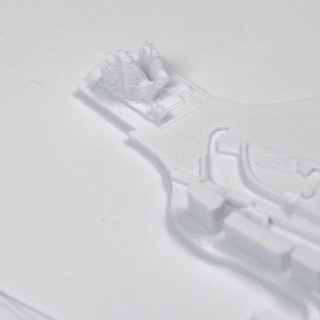 Close view of the Opera House and bridge in a Sydney harbour relief map.