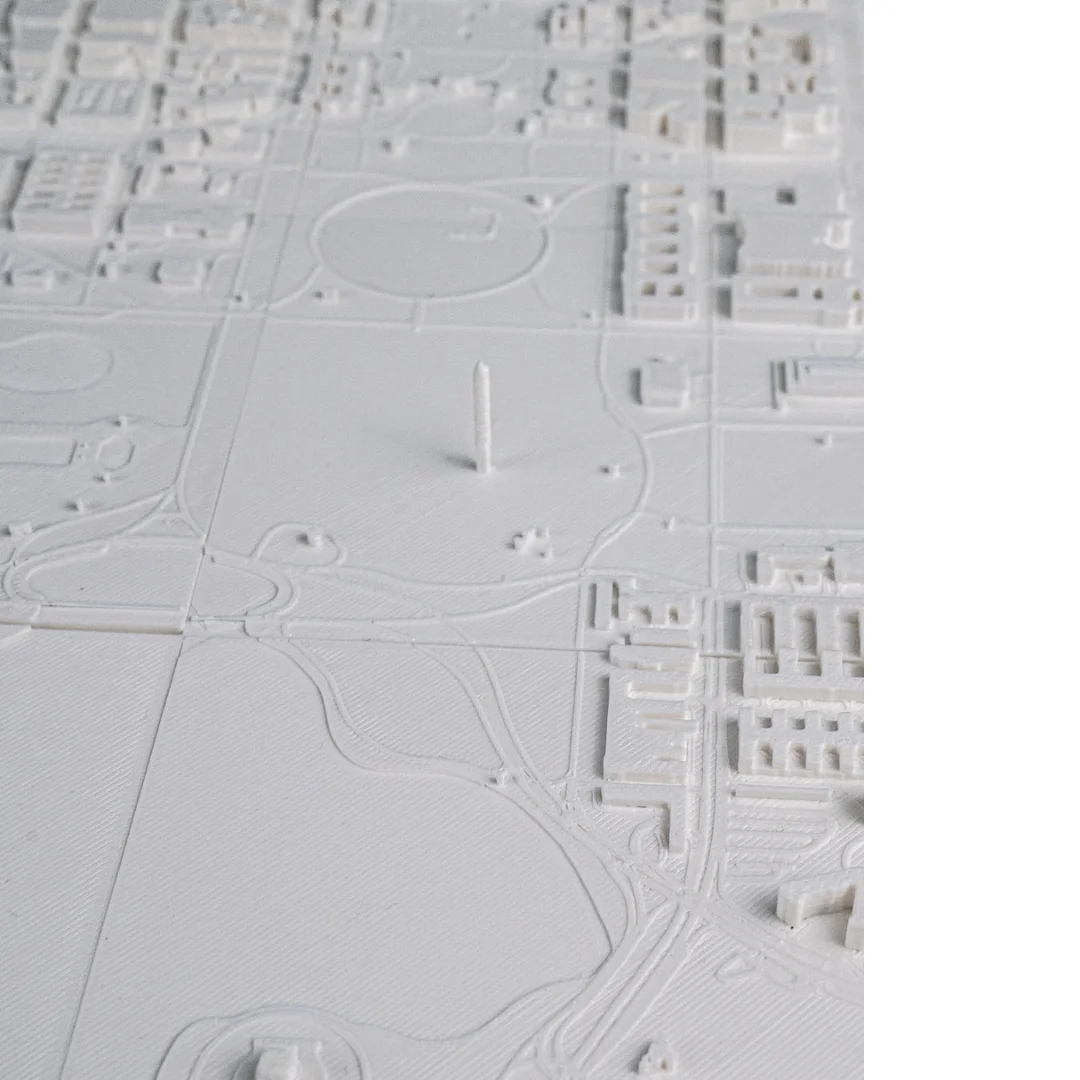 Angled view of the Washington Monument in a city relief map.