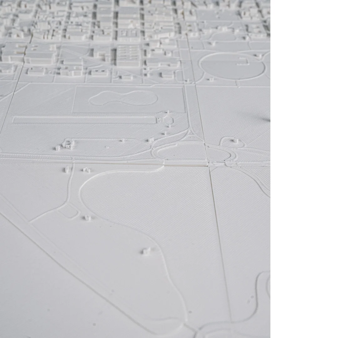 Wide overhead view of monuments and parkland in a Washington DC relief map.
