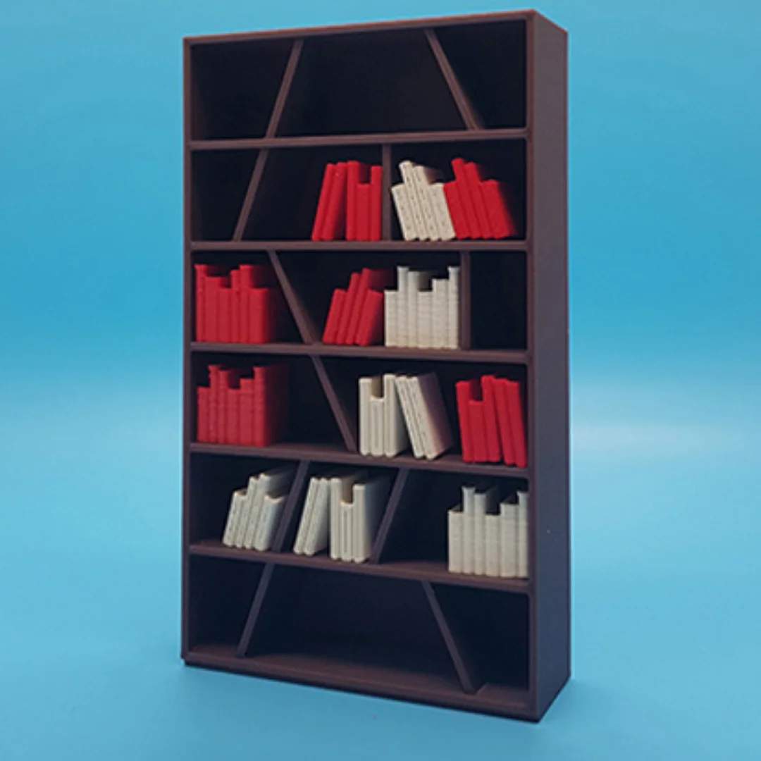 Miniature books arranged on model shelving to illustrate their use in an interior scene.