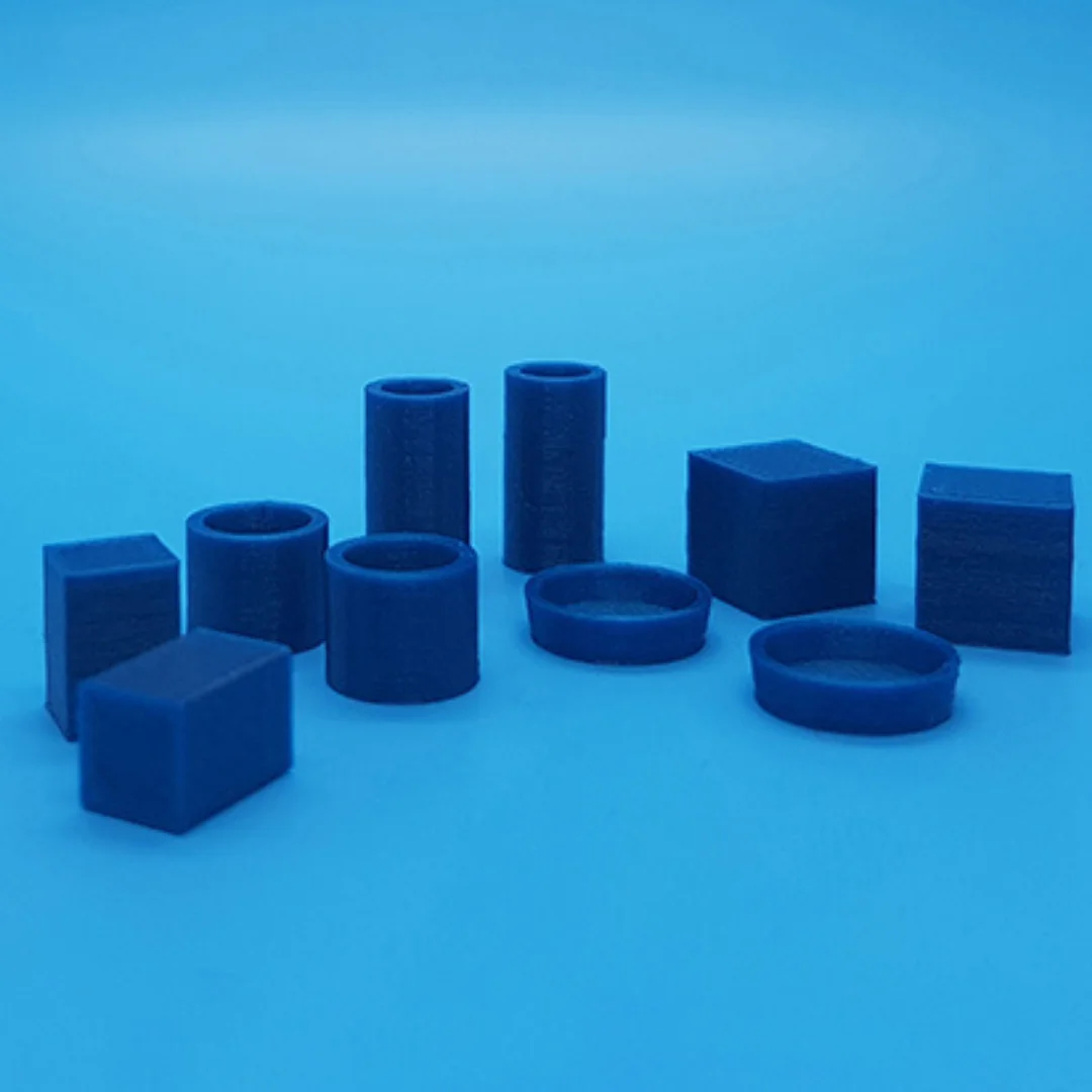 Miniature vases and boxes at 1:20 scale arranged to show their different shapes.
