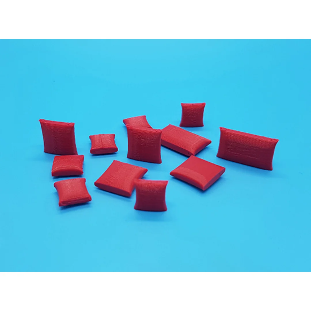 Miniature cushions at 1:50 scale arranged to show their different shapes.