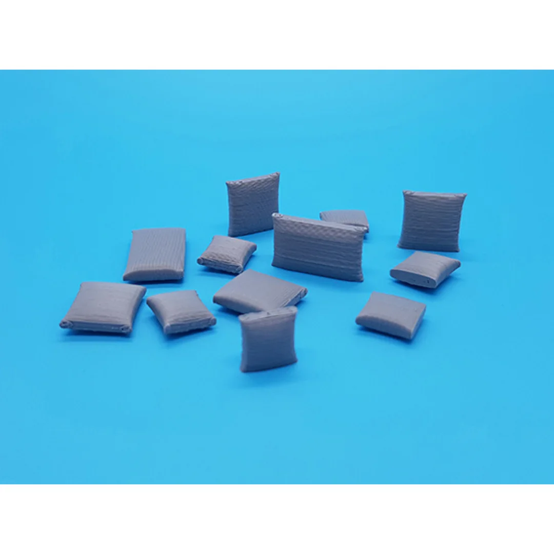Miniature cushions at 1:50 scale arranged to show their different shapes.