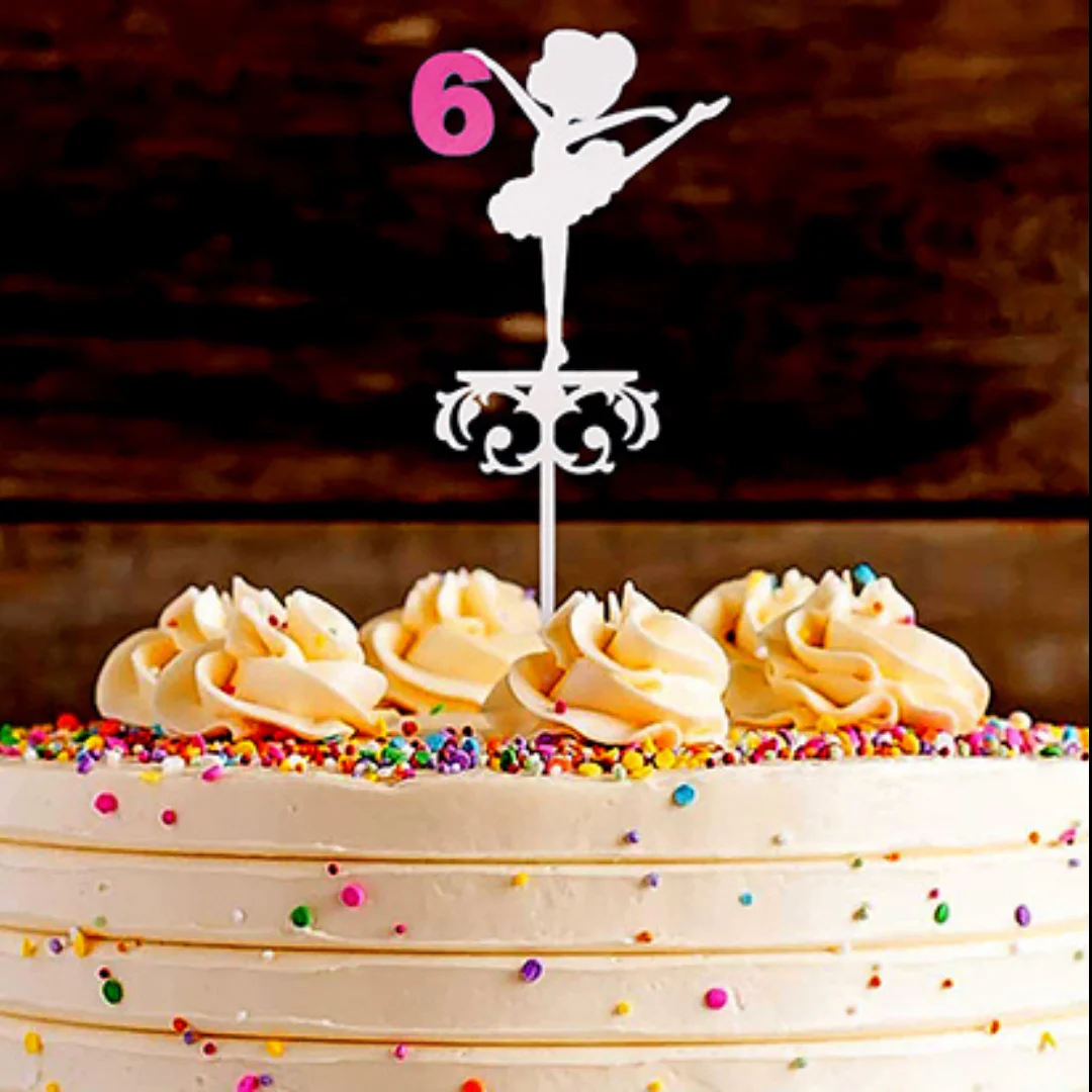 Ballerina birthday cake topper with the number 6 displayed on a decorated cake.