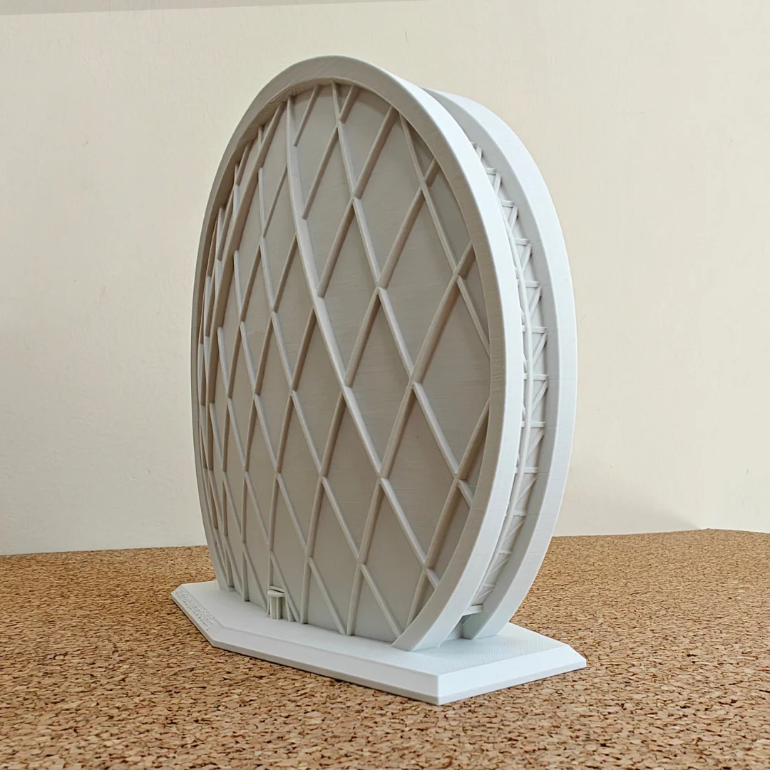 Angled side view of an Aldar Headquarters model and its display base.