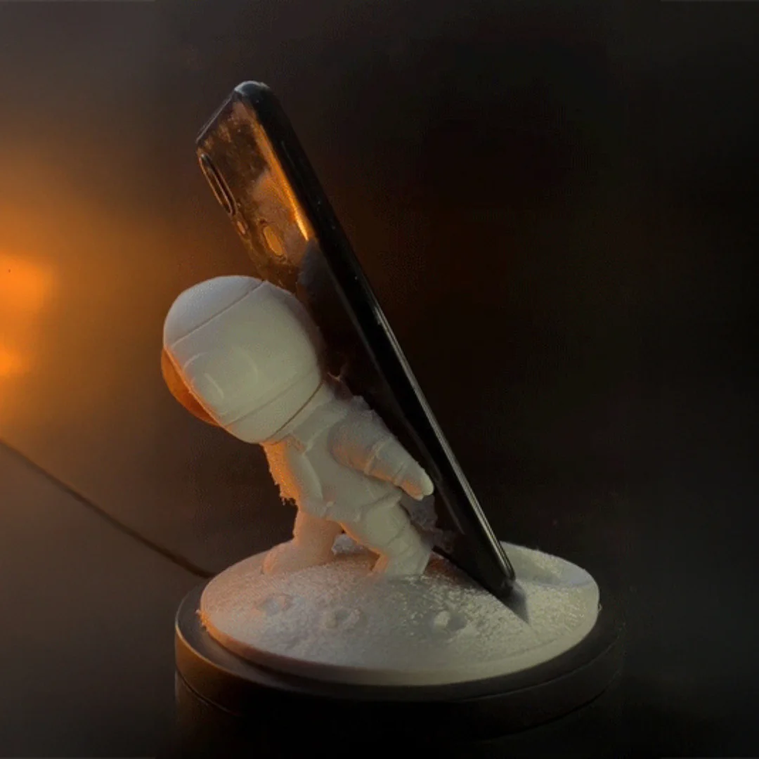 Rear side view of an astronaut phone holder supporting a smartphone.