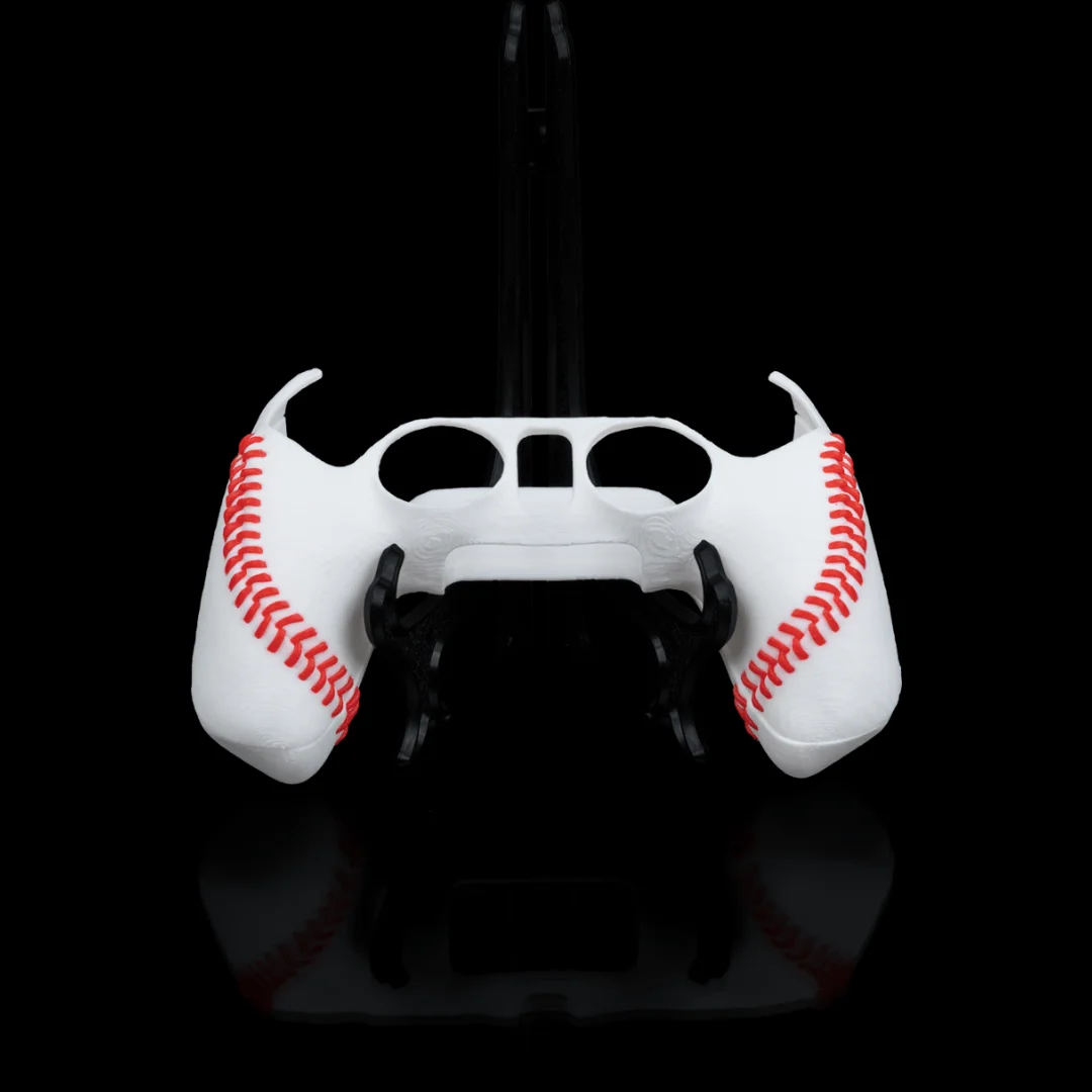 Baseball-style PS5 controller cover with stitched-ball detailing and openings for the controls.