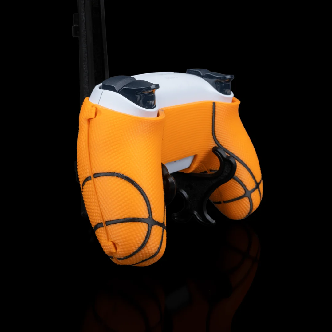 Angled rear view of a PS5 controller fitted with a basketball-style cover.