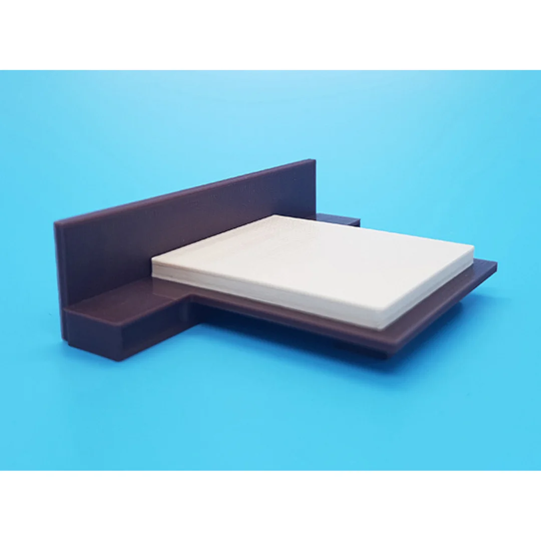 Cora miniature bed at 1:50 scale, showing its headboard, mattress and base.
