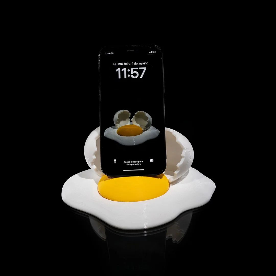 Broken egg phone holder supporting an upright smartphone.