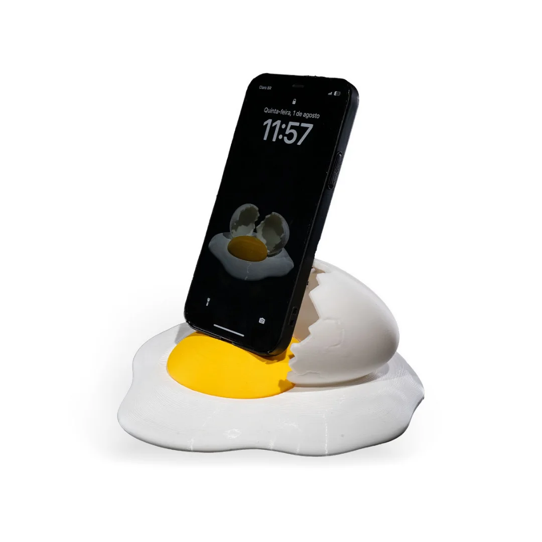 Side angled view of a smartphone resting in a broken egg phone holder.