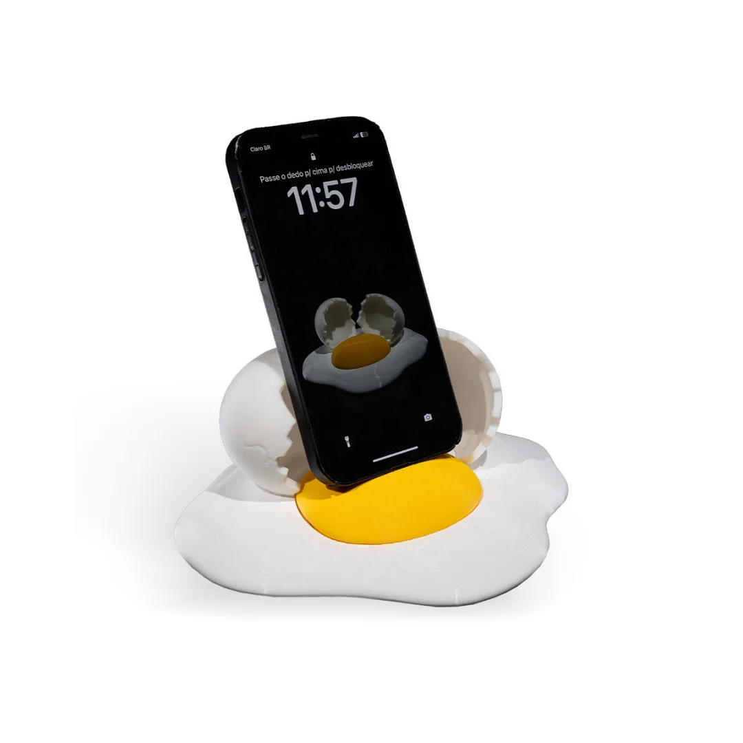 Elevated angled view of a smartphone supported by a broken egg phone holder.