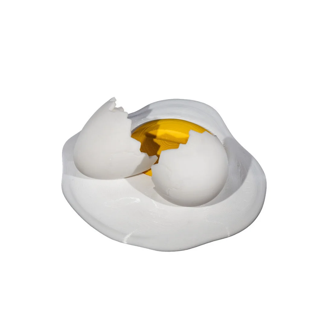 Angled rear view of an empty broken egg phone holder showing the cracked shell design.