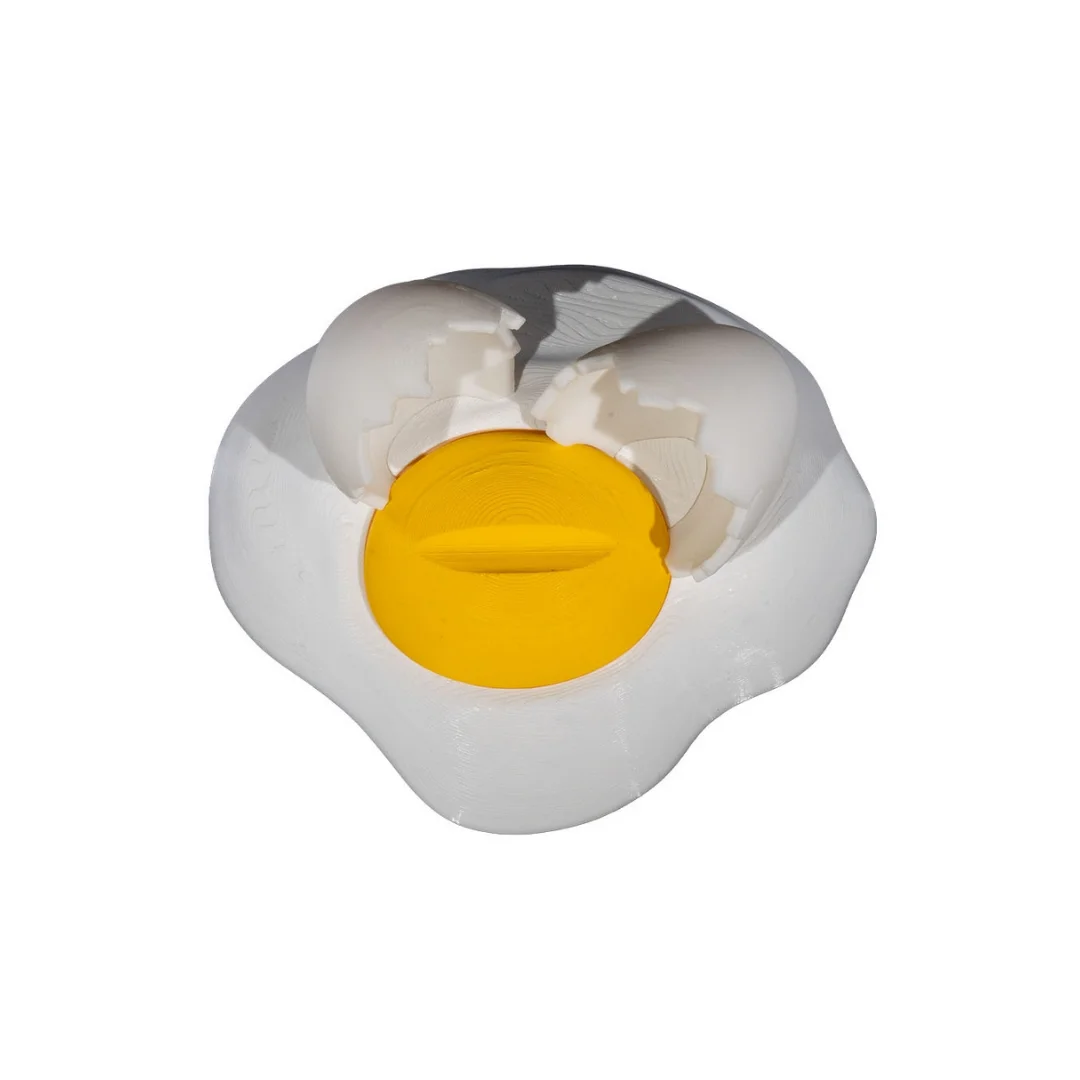Top view of a broken egg phone holder showing the phone slot and yolk detail.