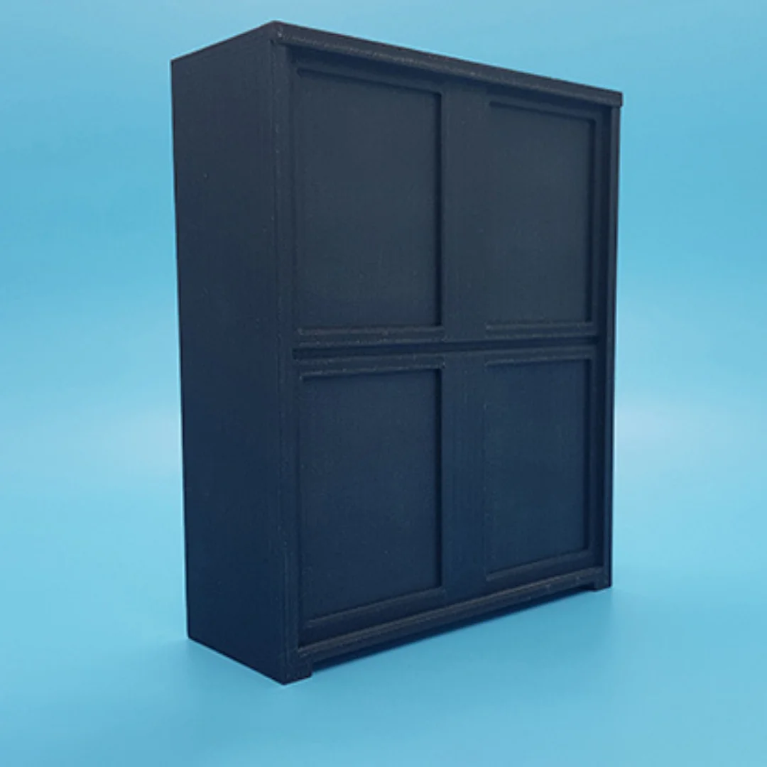 Angled view of the Elegant-2 miniature cabinet at 1:20 scale, showing its panelled front and frame.