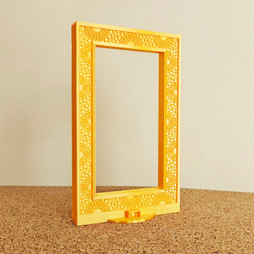 Front angled view of a Dubai Frame model and its decorative facade.