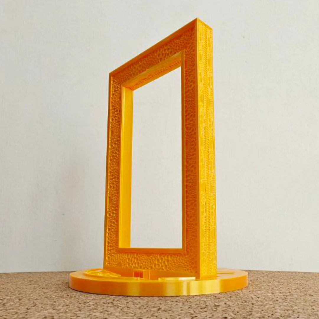 Side angled view of a Dubai Frame model with a circular display base.