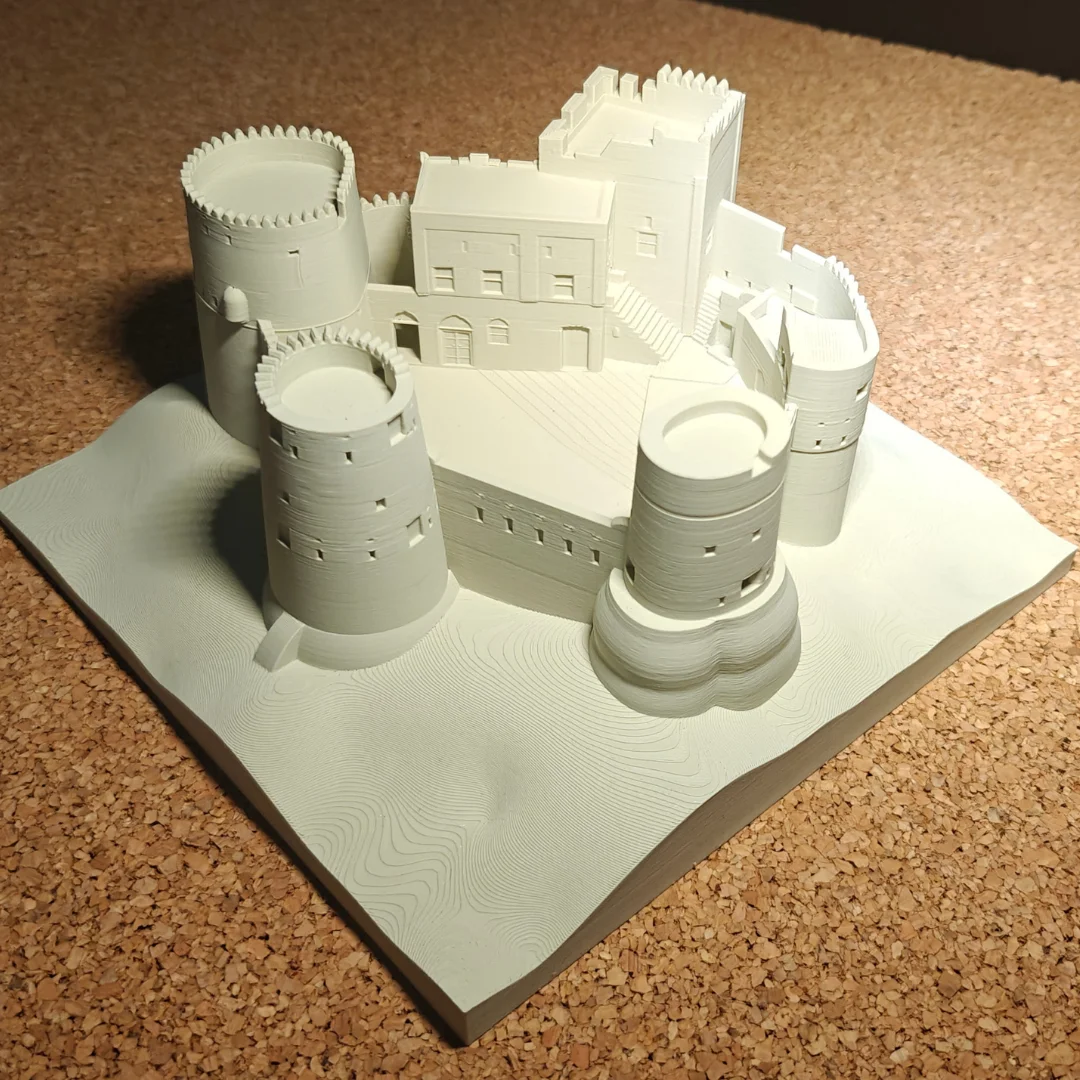 Angled view of a Fujairah Fort model showing its round towers and central building.