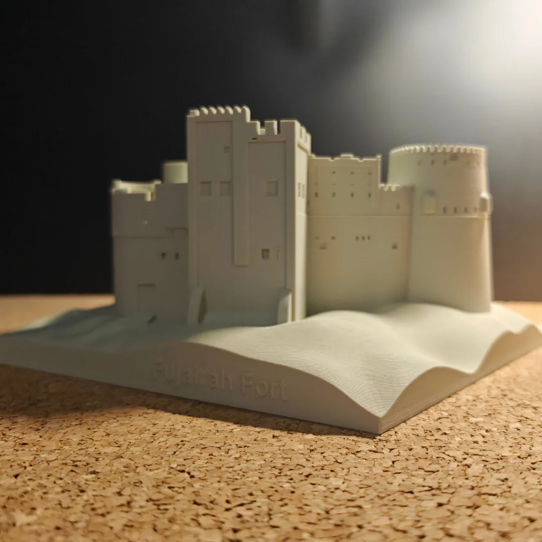 Low front view of a Fujairah Fort model and its contoured base.