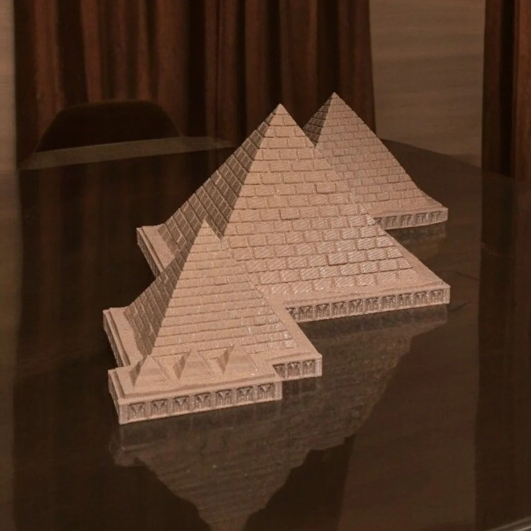 Angled tabletop view of a Giza pyramid complex model.