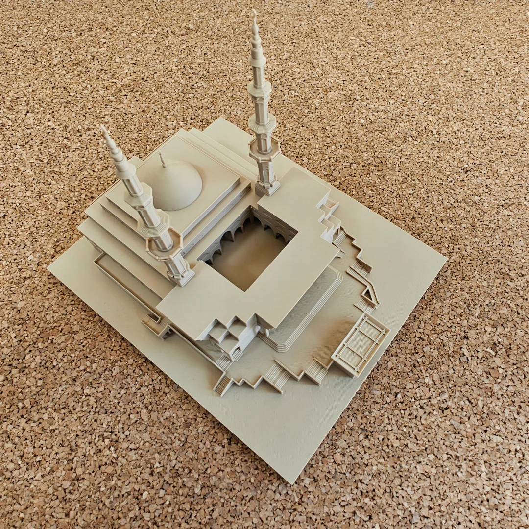 Elevated view of a King Faisal Mosque model showing the dome, minarets and courtyard.