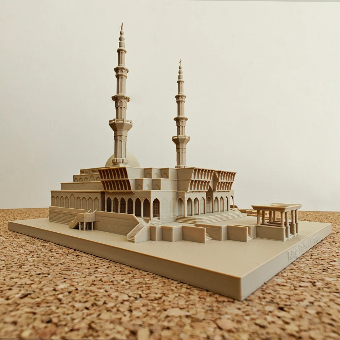 Low angled view of a King Faisal Mosque model with two minarets and entrance details.