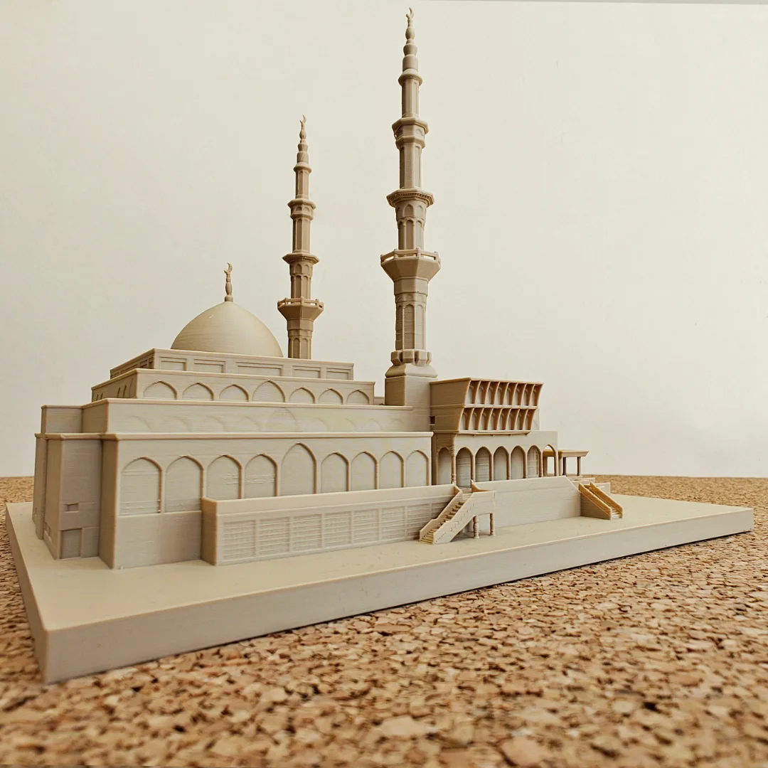 Side view of a King Faisal Mosque model with dome and paired minarets.