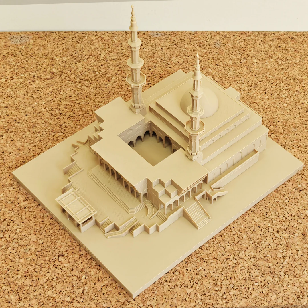 Elevated corner view of a King Faisal Mosque model showing dome and courtyard.